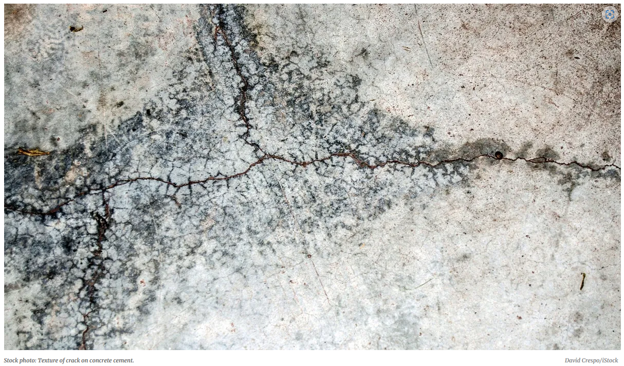 A close-up of a crack in a concrete floor

Description automatically generated