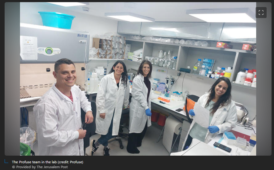 A group of people in lab coats

Description automatically generated