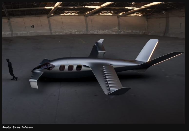 A silver airplane in a hangar

Description automatically generated