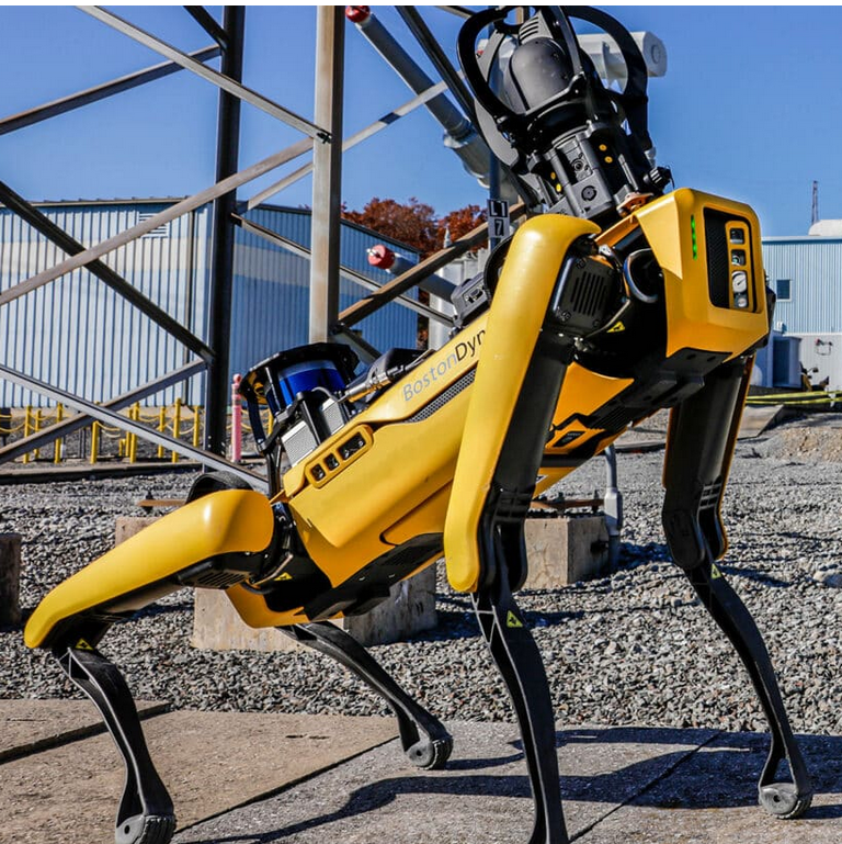 A yellow robot with legs and legs

Description automatically generated