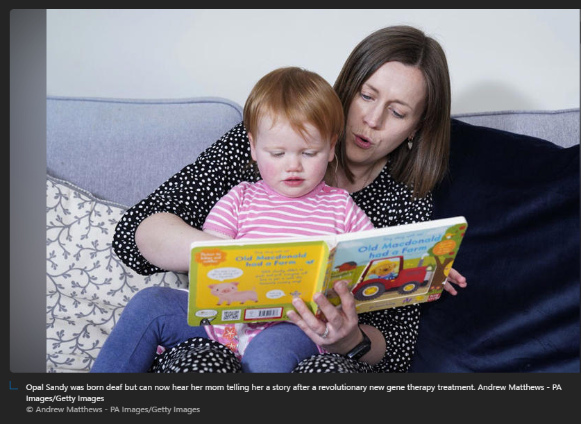 A person and a baby reading a book

Description automatically generated